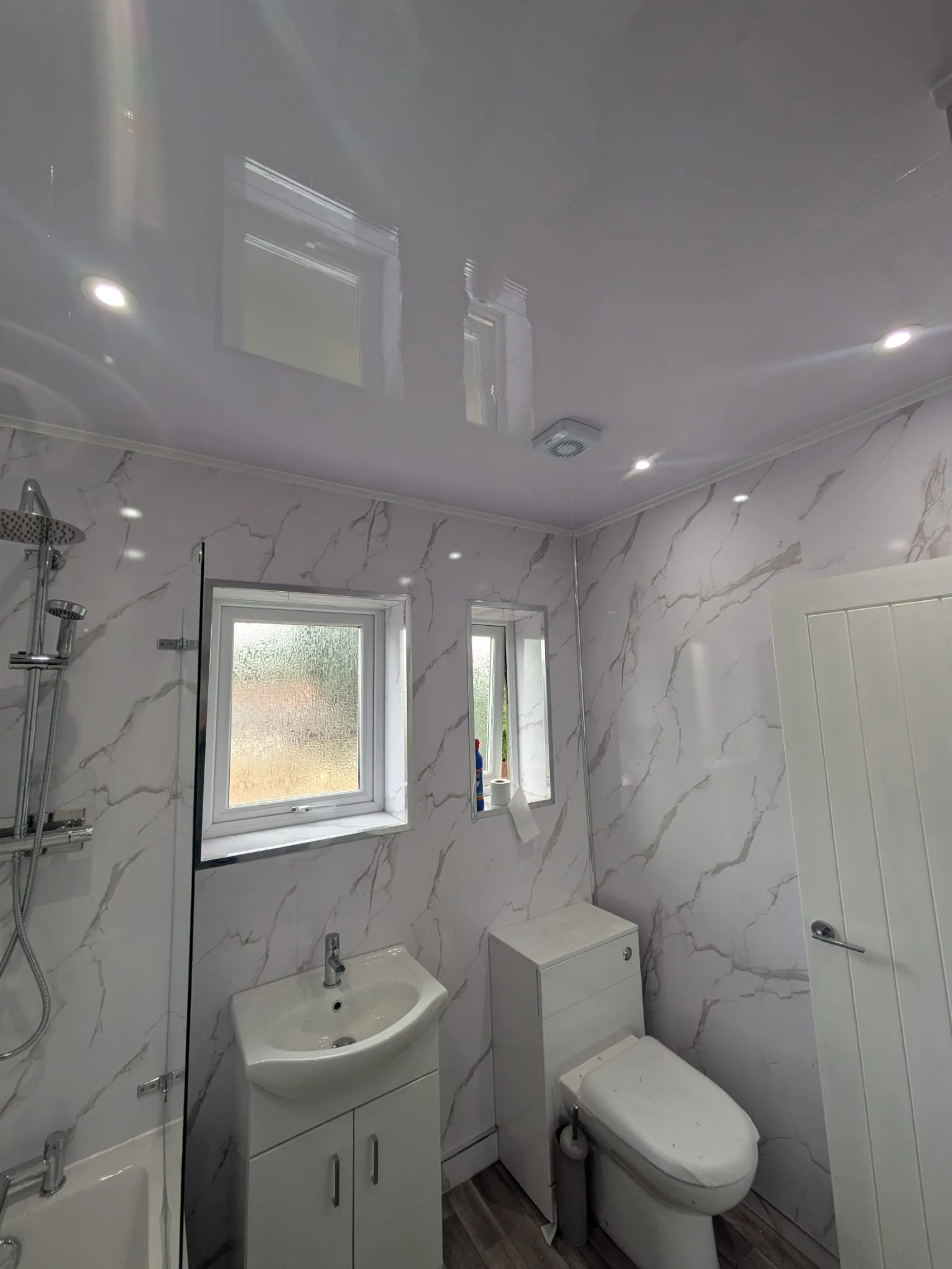 Beautiful marble bathroom with LED spotlights and extractor fan