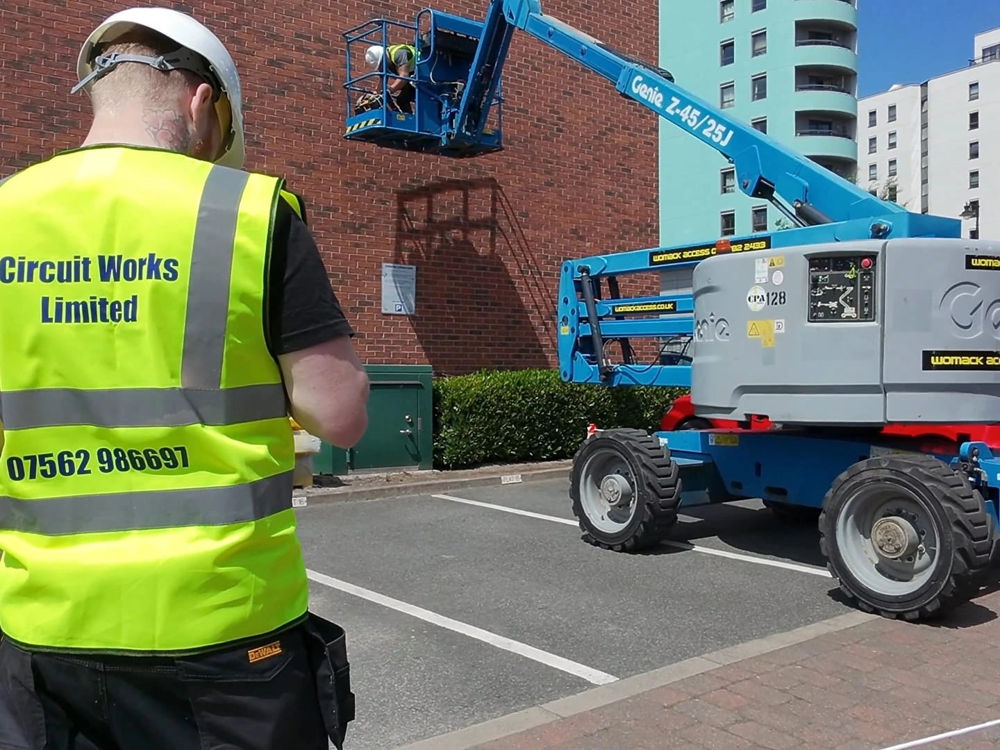 Circuit Works electrician on site in branded hi-vis vest